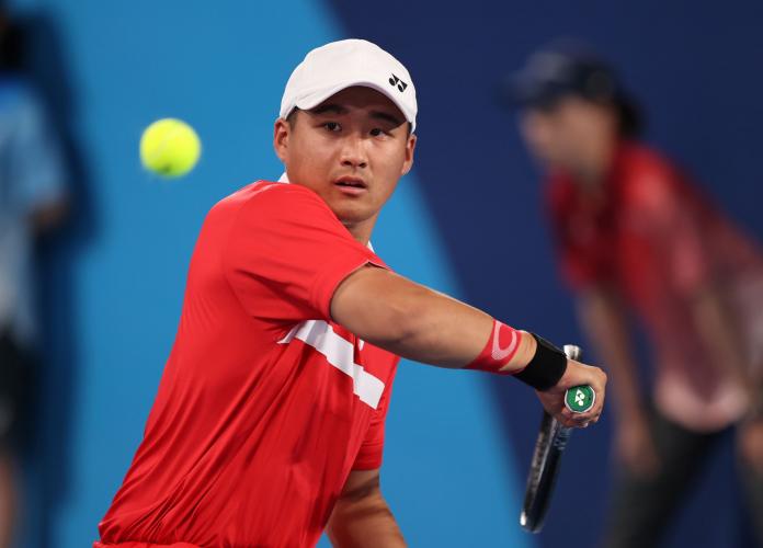 A male wheelchair tennis player in action